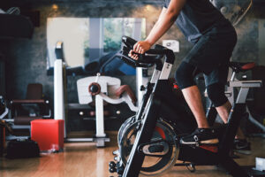 Man exercise by bike at the gym